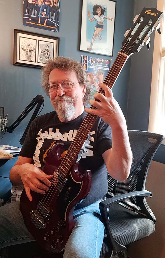 Artist Byron Wilkins with his Conrad bass guitar